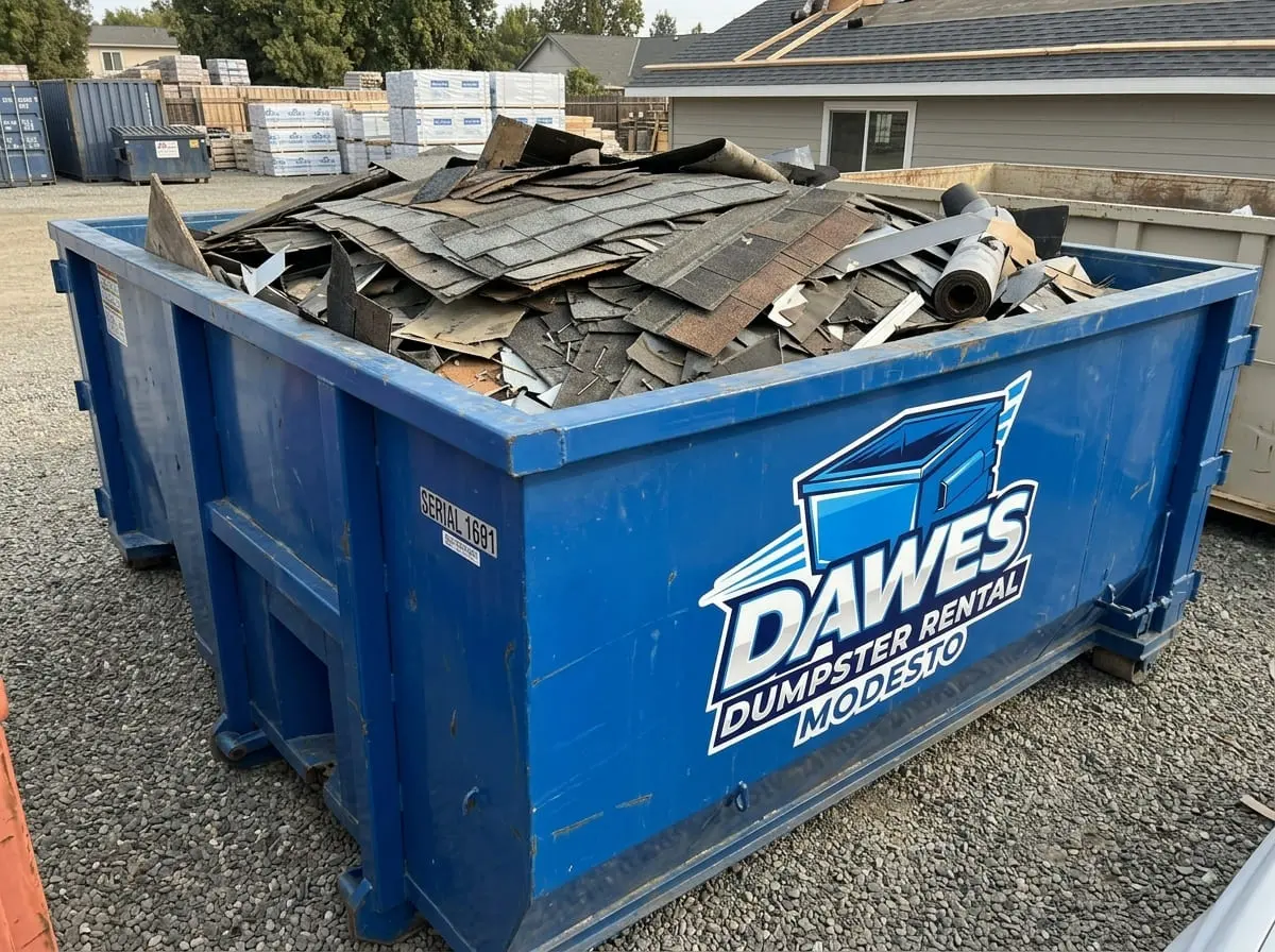 Roofing and heavy debris dumpster rental Dumpster loaded with roofing tear-off debris near Modesto, CA